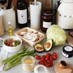 A variety of fresh ingredients and kitchen tools for preparing a healthy meal.