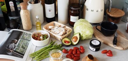 A variety of fresh ingredients and kitchen tools for preparing a healthy meal.